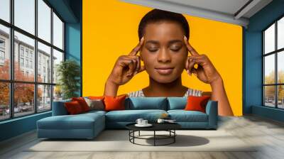 African american woman thinking hard with eyes closed Wall mural