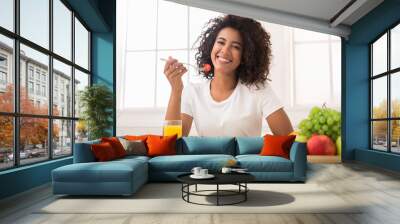 African-american woman with vegetable salad and fresh juice Wall mural