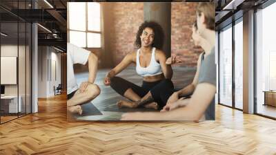 African-american yoga instructor talking to group Wall mural