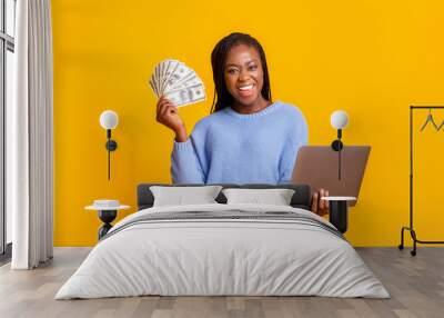 African american young woman making money from internet, using laptop Wall mural