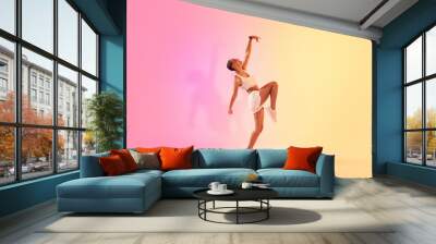 An exuberant young dancer in a dynamic pose captures the essence of movement and grace Wall mural