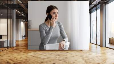 Anxious despair depressed upset caucasian young woman talking by phone, received bad news Wall mural