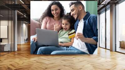 Arabic Family Of Three With Laptop And Credit Card Making Online Shopping Wall mural