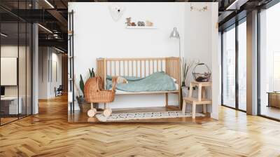 Baby Bedroom Interior with Cozy Wooden Bed And Wicker Stroller Wall mural