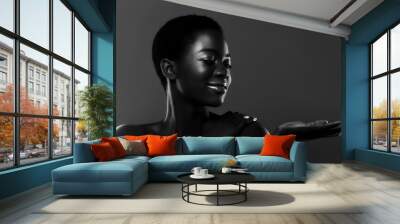 Beautiful african american woman looking at her empty palm, bw shot Wall mural