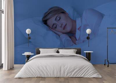 Beautiful mature woman sleeping well on pillow in the night Wall mural