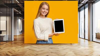 Beautiful teen girl holding digital tablet with blank screen Wall mural