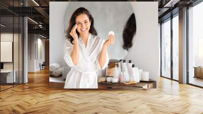 Beautiful young brunette woman using cotton pads in bathroom Wall mural