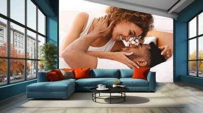 Beautiful young man and woman in morning in bed Wall mural