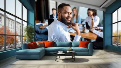 Black Businessman Smiling To Camera Sitting On Meeting In Office Wall mural