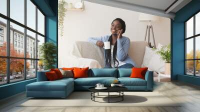 Black Girl Talking on Cellphone And Drinking Morning Coffee At Home Wall mural