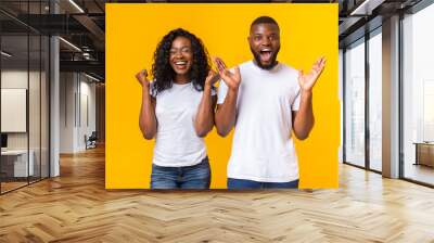 Black guy and girl happily surprised with good news Wall mural