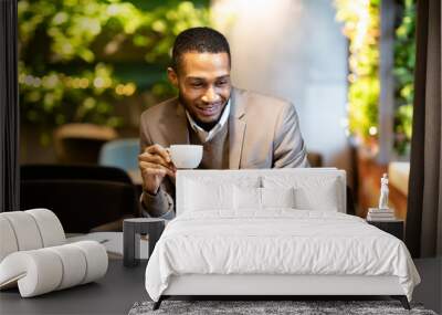 Black guy drinking tea and using his pc Wall mural