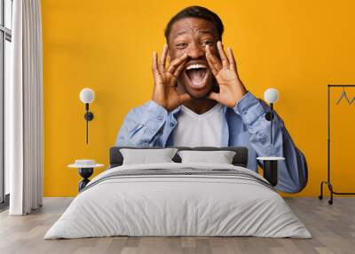 Black Guy Screaming Holding Hands Near Mouth, Studio Shot Wall mural