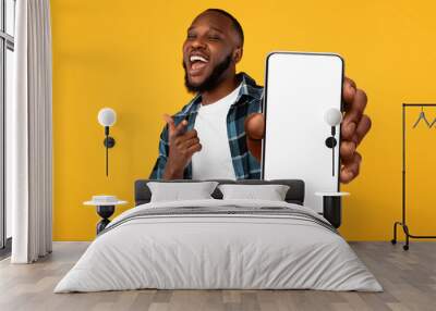 Black guy showing white empty smartphone screen, closeup Wall mural