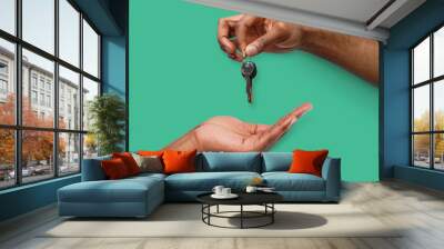 Black man handing key over to person hand Wall mural