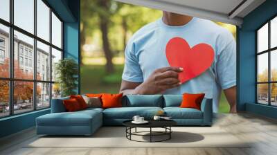 Black man holding red heart on his chest Wall mural