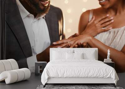 Black man putting ring on his woman finger Wall mural