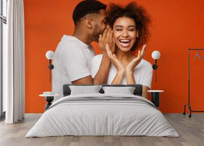 Black man sharing secret with his girlfriend Wall mural