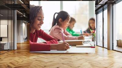 Black Schoolgirl Writing Learning With Multicultural Classmates In Classroom, Panorama Wall mural