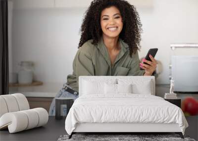 Black Woman Using App On Phone Taking Notes At Kitchen Wall mural