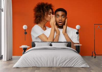 Black woman whispering her desires to shocked boyfriend Wall mural