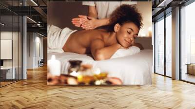 Body care. Woman enjoying relaxing back massage Wall mural