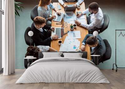 Business Colleagues Working Using Gadgets Sitting In Modern Office, Above-View Wall mural