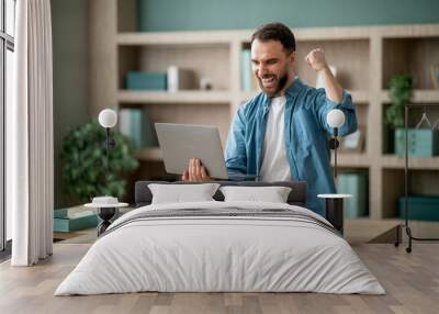 Business Success. Young Happy Businessman Celebrating Success With Laptop In Office Wall mural