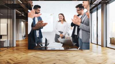 Business team congratulating successful female manager with applause Wall mural