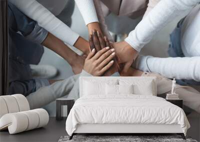 Business team putting hands together on top of each other Wall mural