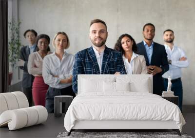 Businessman Standing In Front Of His Business Team In Office Wall mural