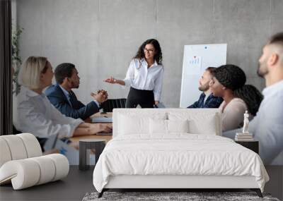 Businesswoman Making Business Presentation For Colleagues In Modern Office Wall mural