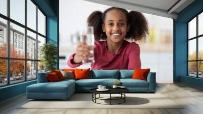 Cheerful african american girl teenager holding glass of fresh water Wall mural