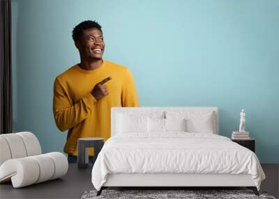 Cheerful african american millennial man pointing at copy space, panorama Wall mural