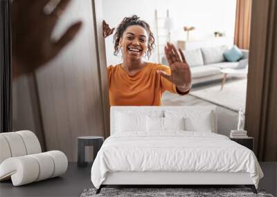 Cheerful African American Woman Waving Hand Meeting Somebody At Home Wall mural