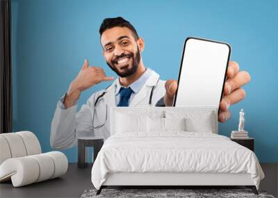 Cheerful Arab Doctor Male Gesturing Call Me, Holding Smartphone Wall mural