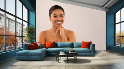 Cheerful beautiful young black woman looking at copy space Wall mural