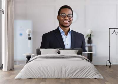 Cheerful black man manager holding digital tablet, office interior Wall mural