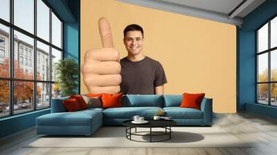 Cheerful guy showing thumb up, big gestures concept Wall mural