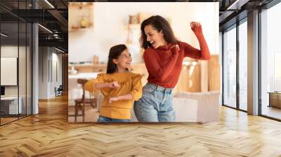 Cheerful Middle Eastern Mother And Daughter Kid Dancing At Home Wall mural