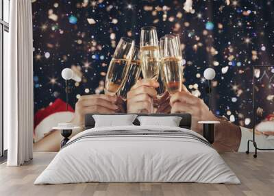 Clinking glasses of champagne in hands at New Year party Wall mural