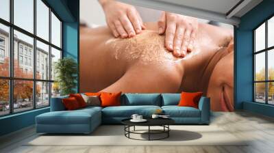 Closeup of black girl having skin peeling massage at spa Wall mural