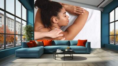 Closeup of black young woman having healing body massage Wall mural