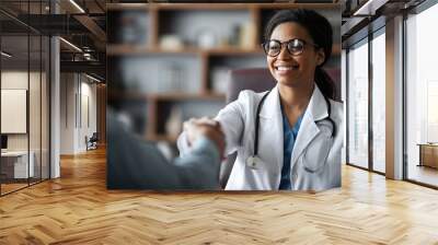 Closeup of friendly black lady doctor shaking male patient hand Wall mural