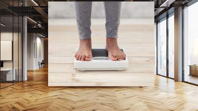 Closeup of young African American woman standing on scales indoors, checking her weight, cropped view of feet Wall mural