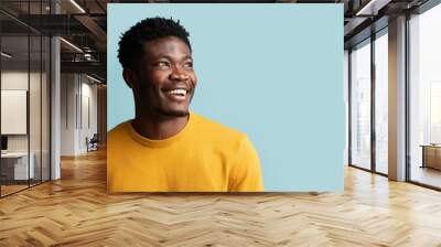 closeup portrait of cheerful black guy looking at copy space Wall mural