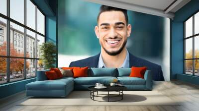 Closeup portrait of happy middle-eastern young businessman Wall mural