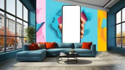 Collage of hands showing empty smartphone screen breaking through paper Wall mural