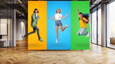 Collage of happy millennial people jumping on colorful studio backgrounds Wall mural